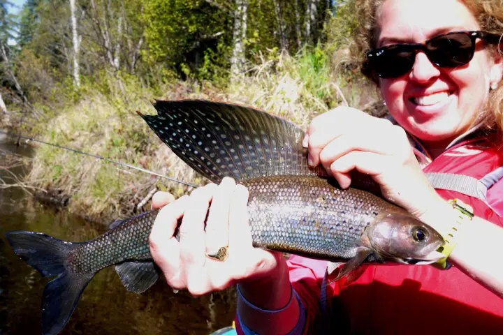 a person holding a fish