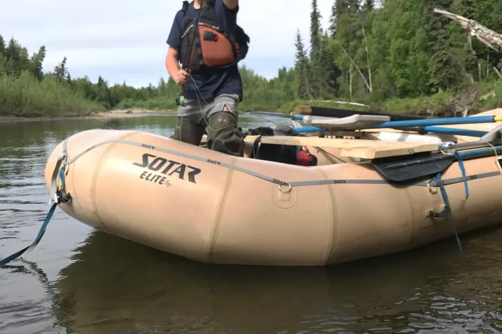 a person riding on the back of a boat in the water