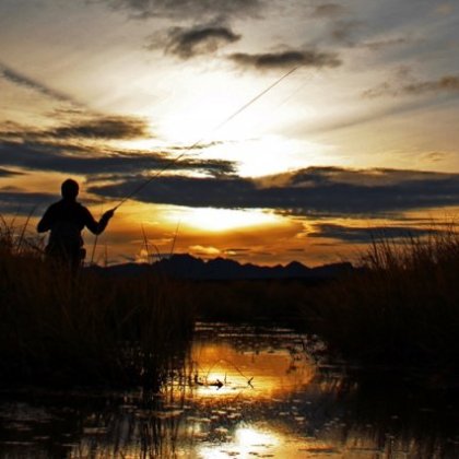 a person standing in front of a sunset