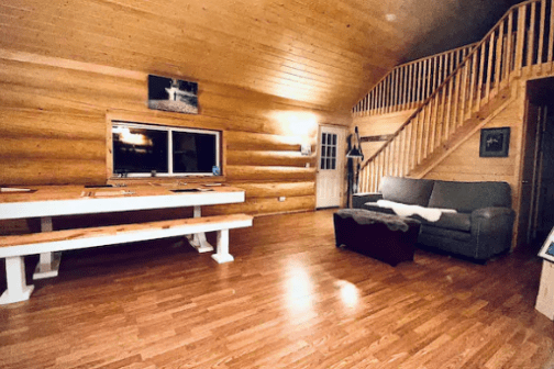 a living room filled with furniture on top of a hard wood floor