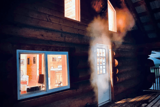 a fire place sitting in a dark room
