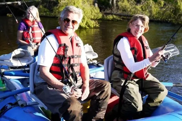 a group of people sitting on a raft in a body of water
