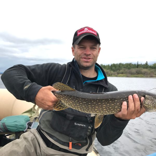 a man holding a fish in the water