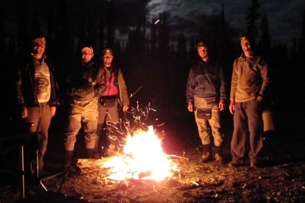 a group of people standing around a fire