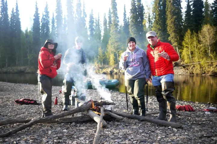 a group of people standing around a fire