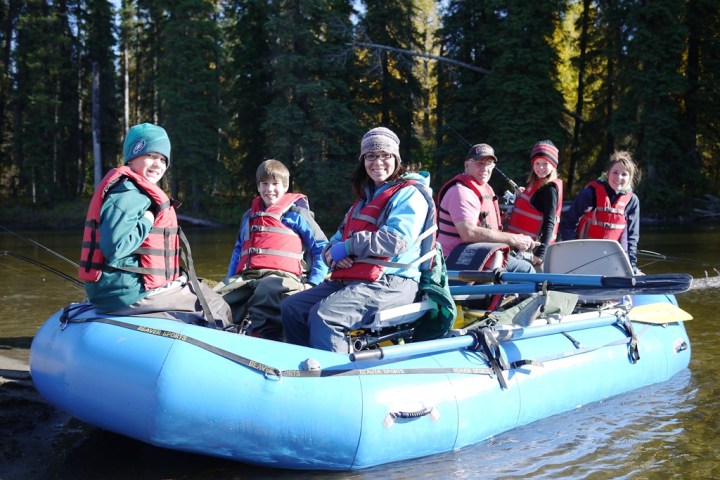 a group of people riding on the back of a boat