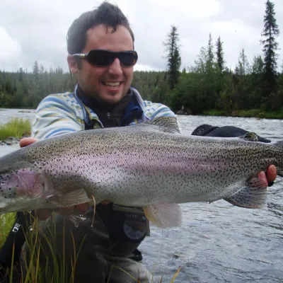a man holding a fish in the water