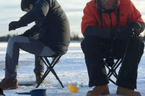 a person standing next to a body of water