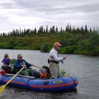a group of people in a small boat in a body of water