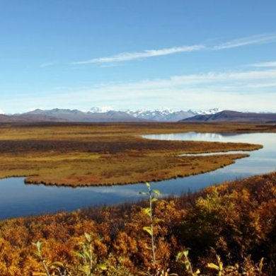 a body of water with a mountain in the background