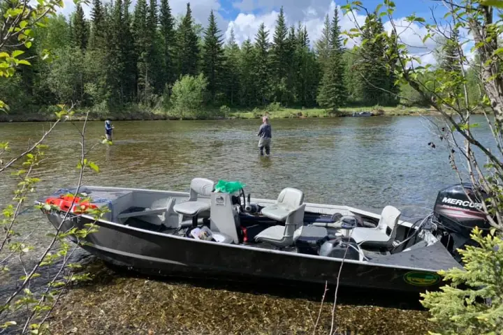 a boat parked on the side of a river