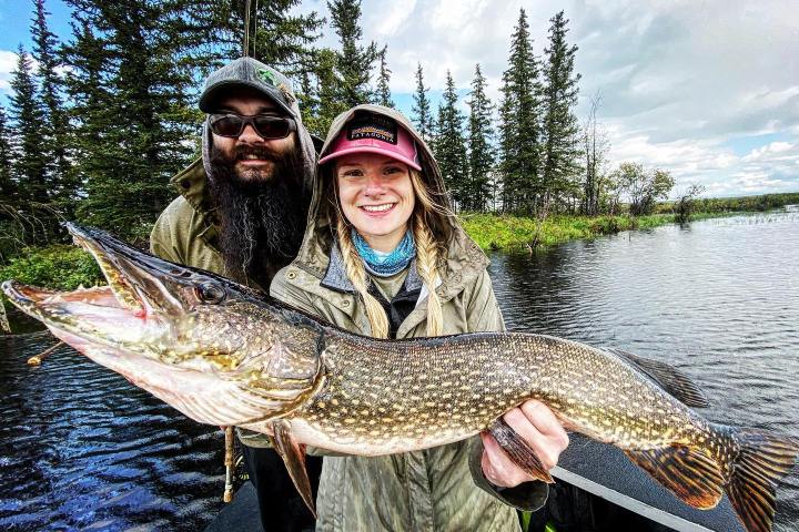 a person holding a fish in the water
