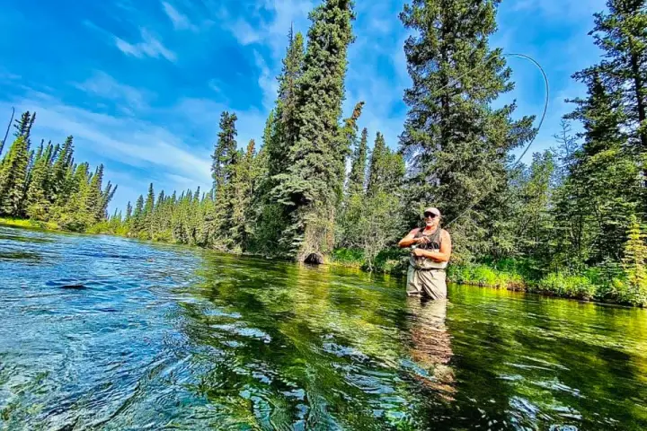 a man standing in front of a pond