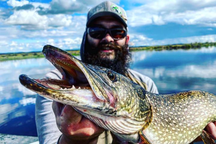 a man holding a fish in the water