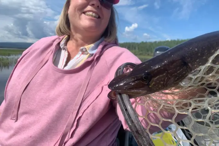 a person holding a fish