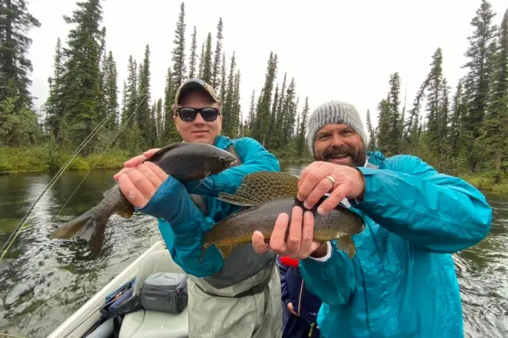a young boy holding a fish