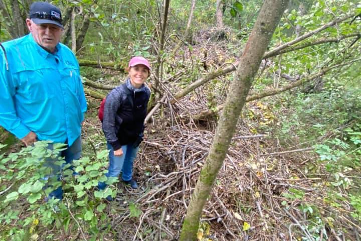 a man standing next to a tree