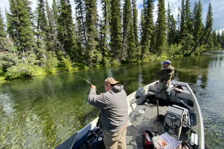 a man riding a motorcycle down a river