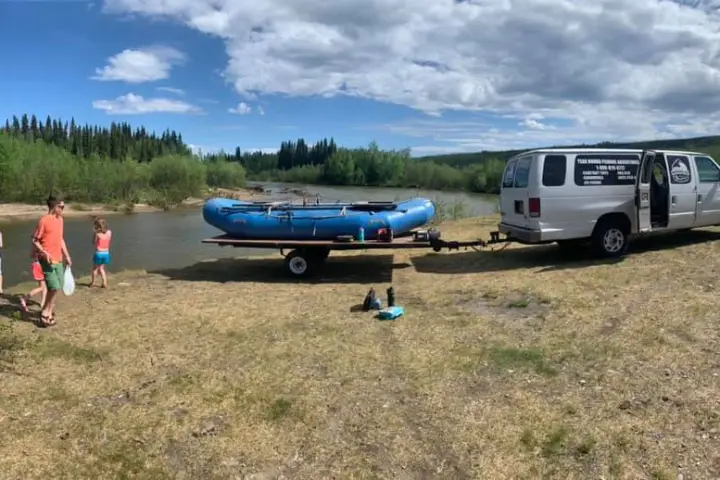 a group of people standing on top of a car