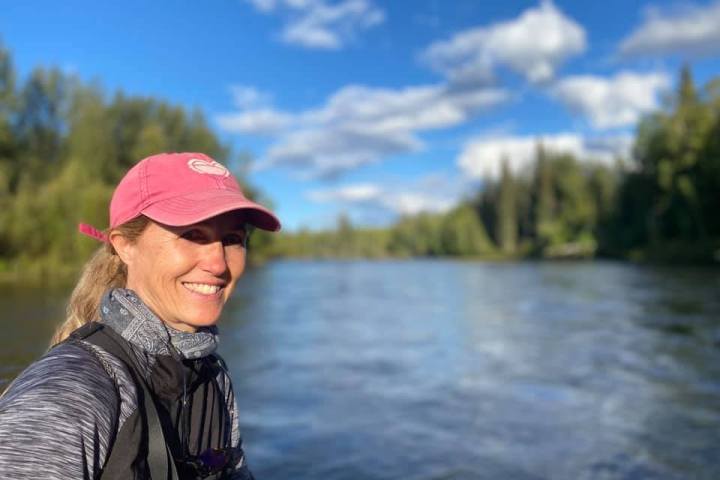 a person standing next to a body of water