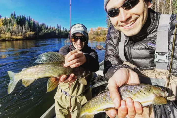 a person holding a fish in the water