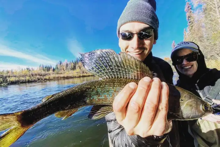 a person holding a fish in the water