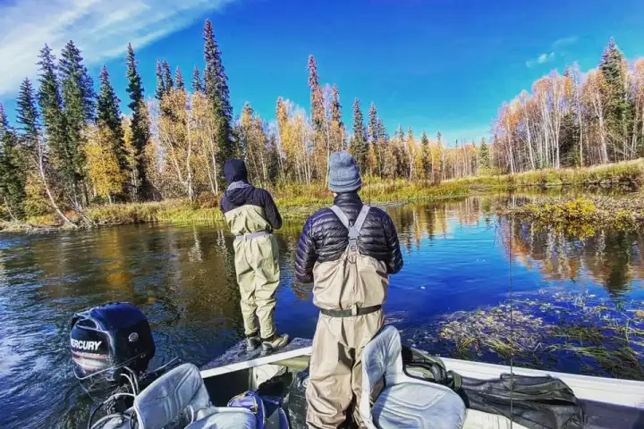 a person standing next to a body of water