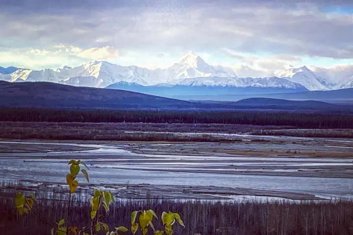 a body of water with a mountain in the background