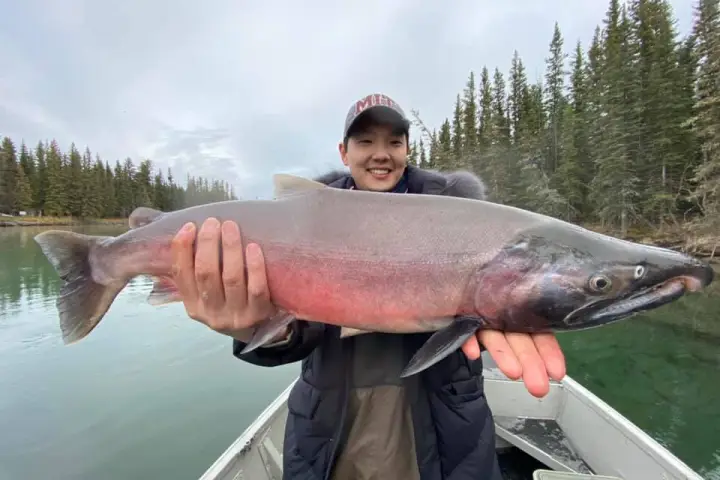 a man holding a fish in the water