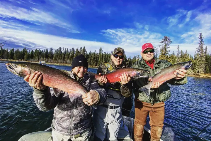 a man holding a fish in the water