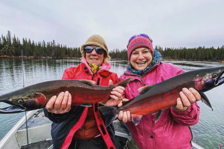 a person holding a fish in the water