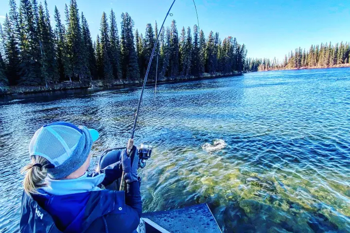 a group of people standing next to a body of water