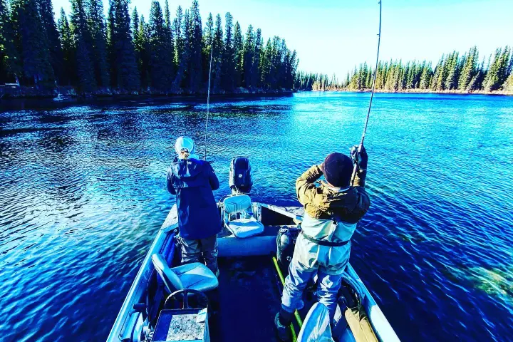 a person standing next to a body of water