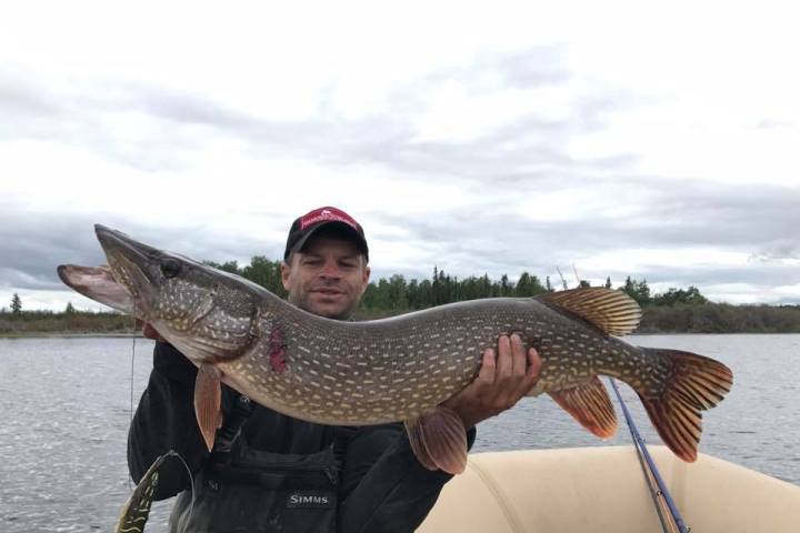 a man holding a fish