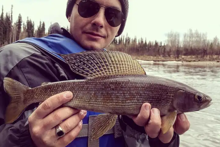 a person holding a fish