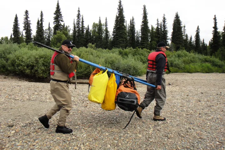 a group of people walking down a dirt road