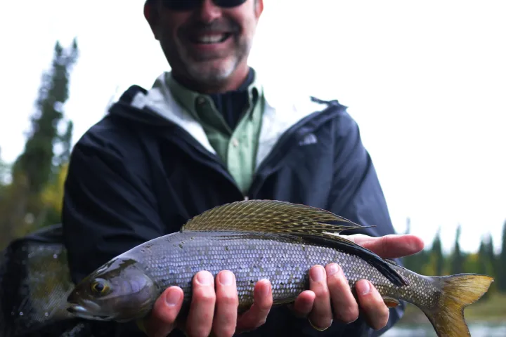 a man holding a fish