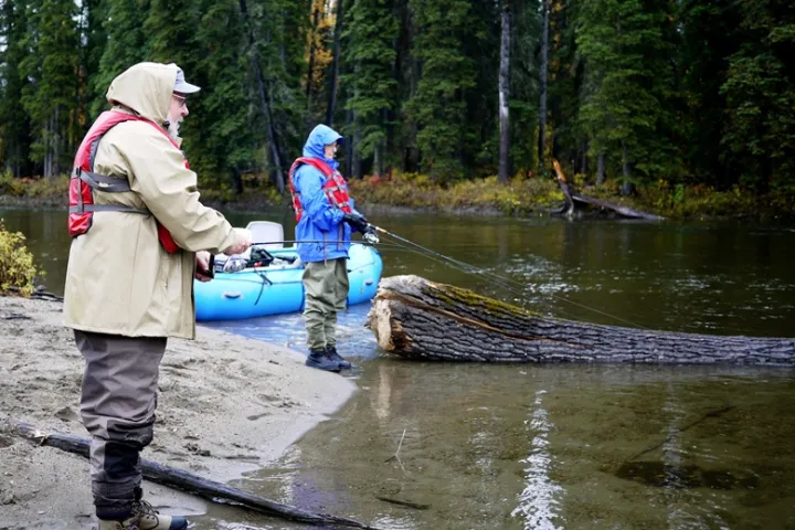 a couple of people that are standing in the water