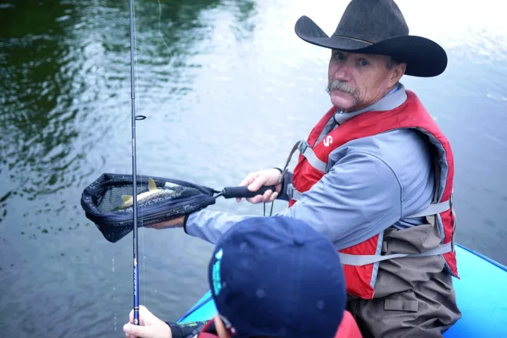 Dale Earnhardt riding on the back of a boat