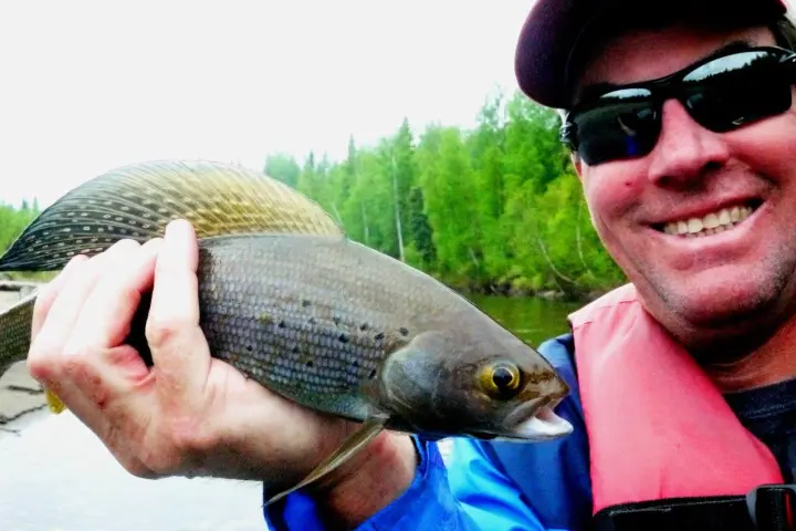 a man holding a fish