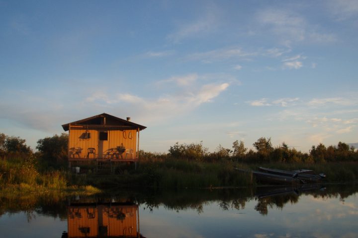 a train traveling down tracks next to a body of water