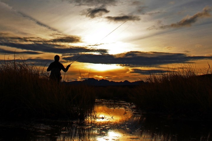a person standing in front of a sunset