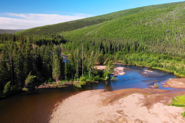 a body of water with a mountain in the background
