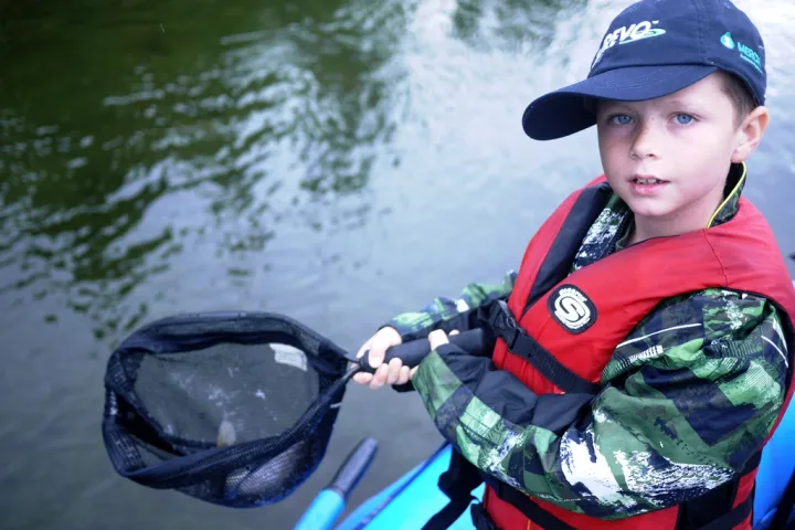 a young boy wearing a helmet