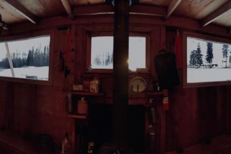 a room with a fireplace and a large window