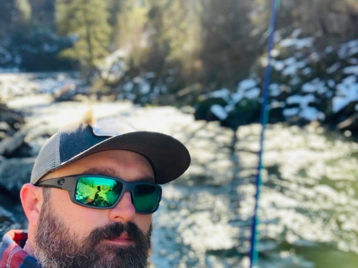 a man wearing a hat and sunglasses