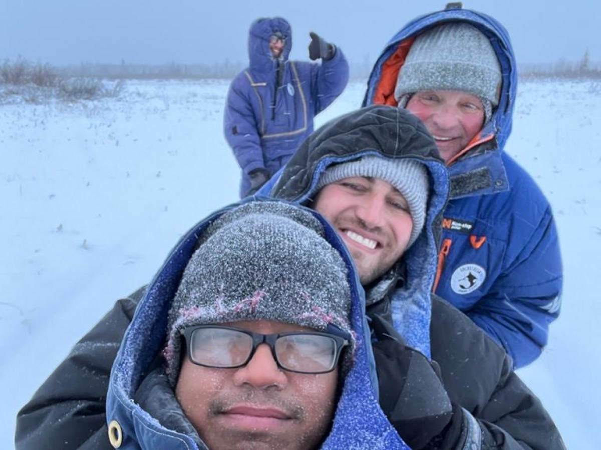 a group of people sitting in the snow